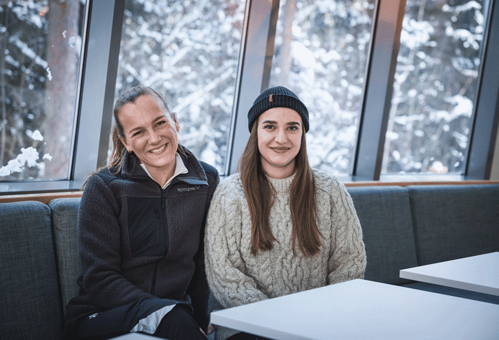et par personr som sitter ved et bord og smiler til kameraet